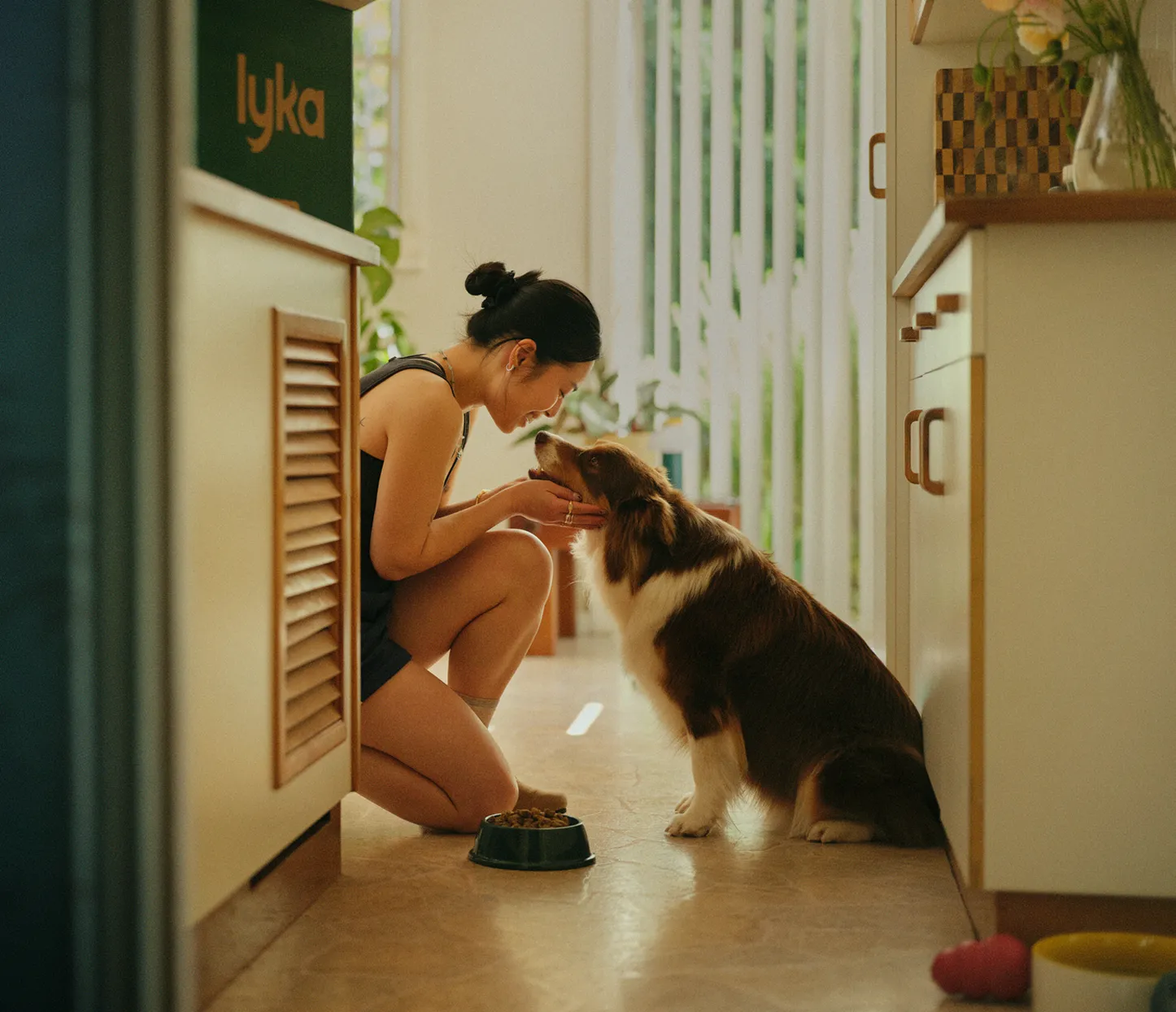 A lady patting her happy dog