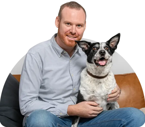 Dr Matthew Muir with his dog on his lap